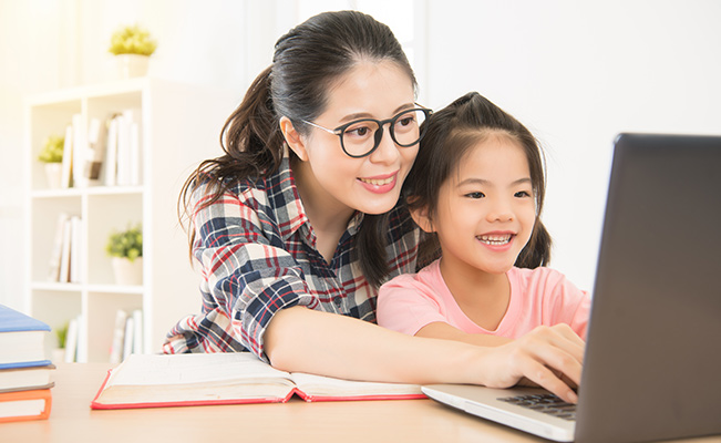 Back to school:  Mom helping daughter with online classes