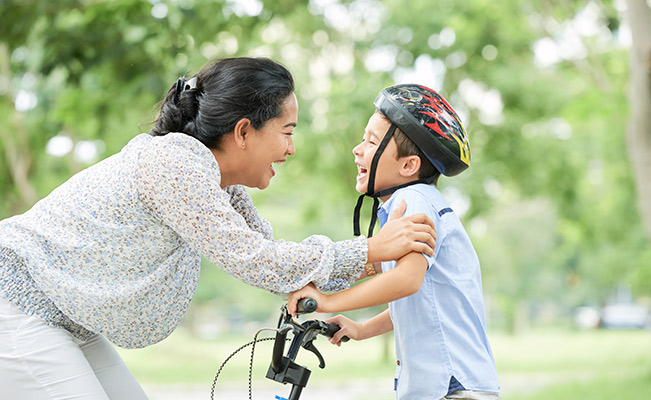 Emotional Quotient: Mom teaching child to ride bicycle