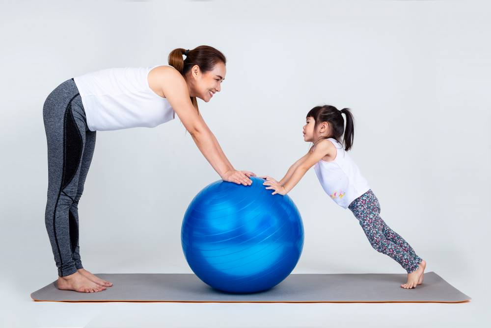 Mom and kid exercising to prevent constipation