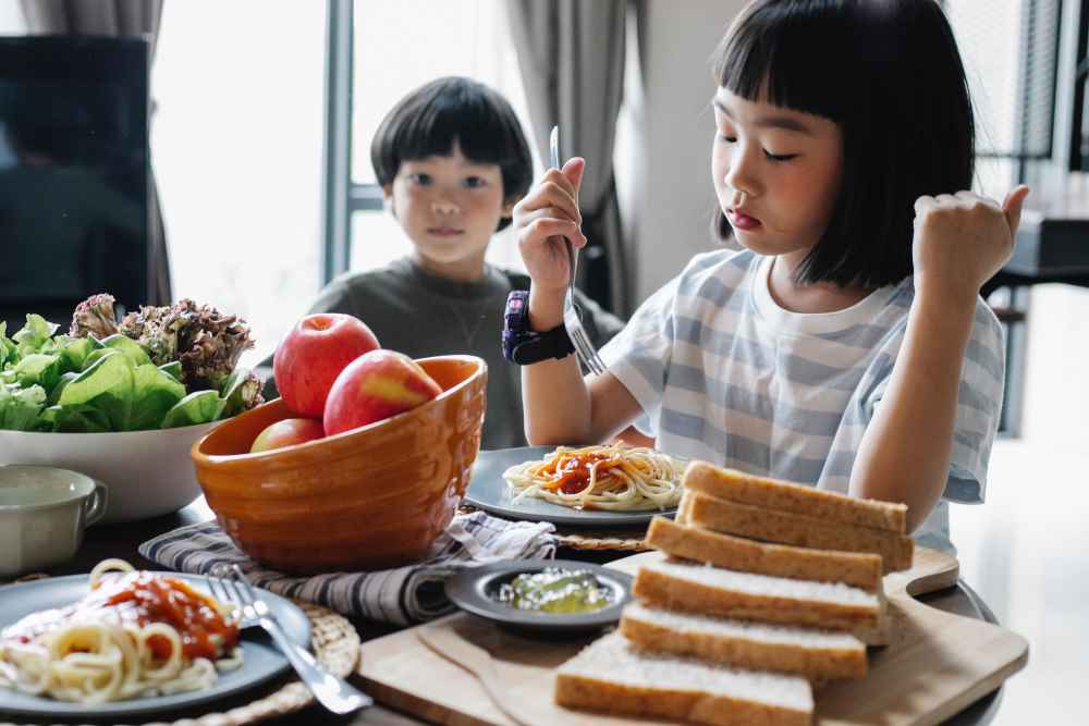 Two kids eating whole food for tummy health