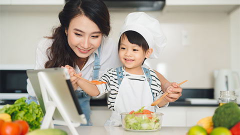 Child learning to cook