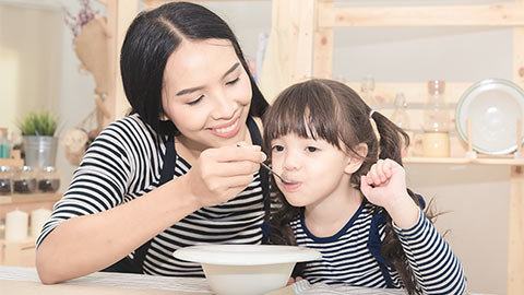 Mom feeding child