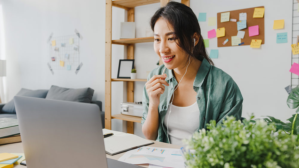 asia-businesswoman-using-laptop-talk-colleagues-about-plan-video-call-while-smart-working-from-home-living-room